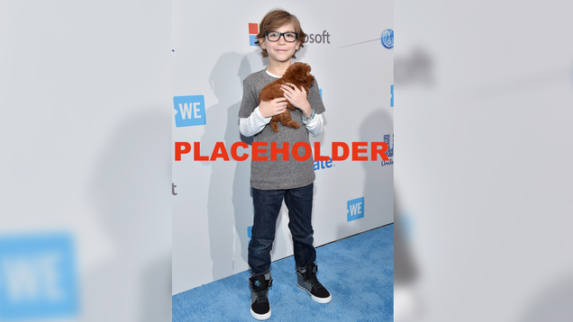 Jacob Tremblay holding a dog.
